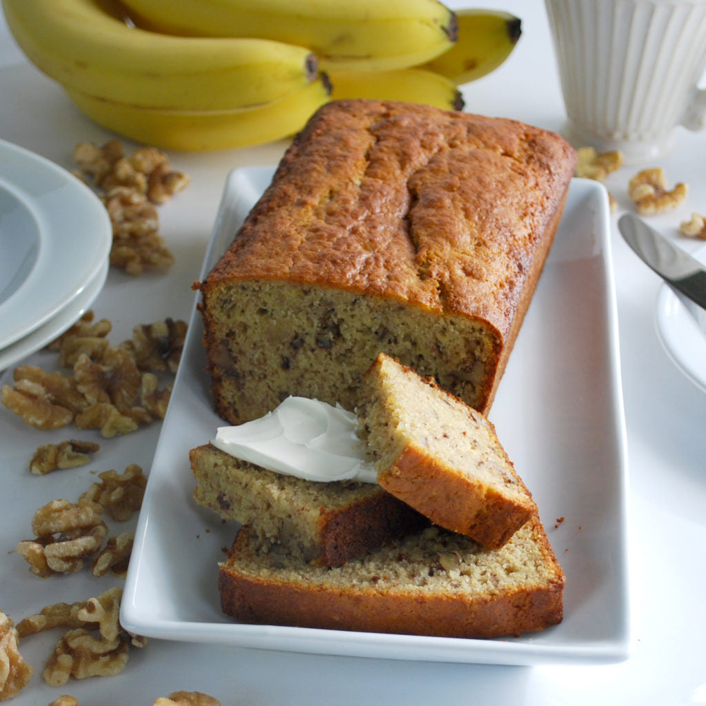 Gluten-free banana bread made with Pamela's Pancake & Baking Mix, sliced on a board