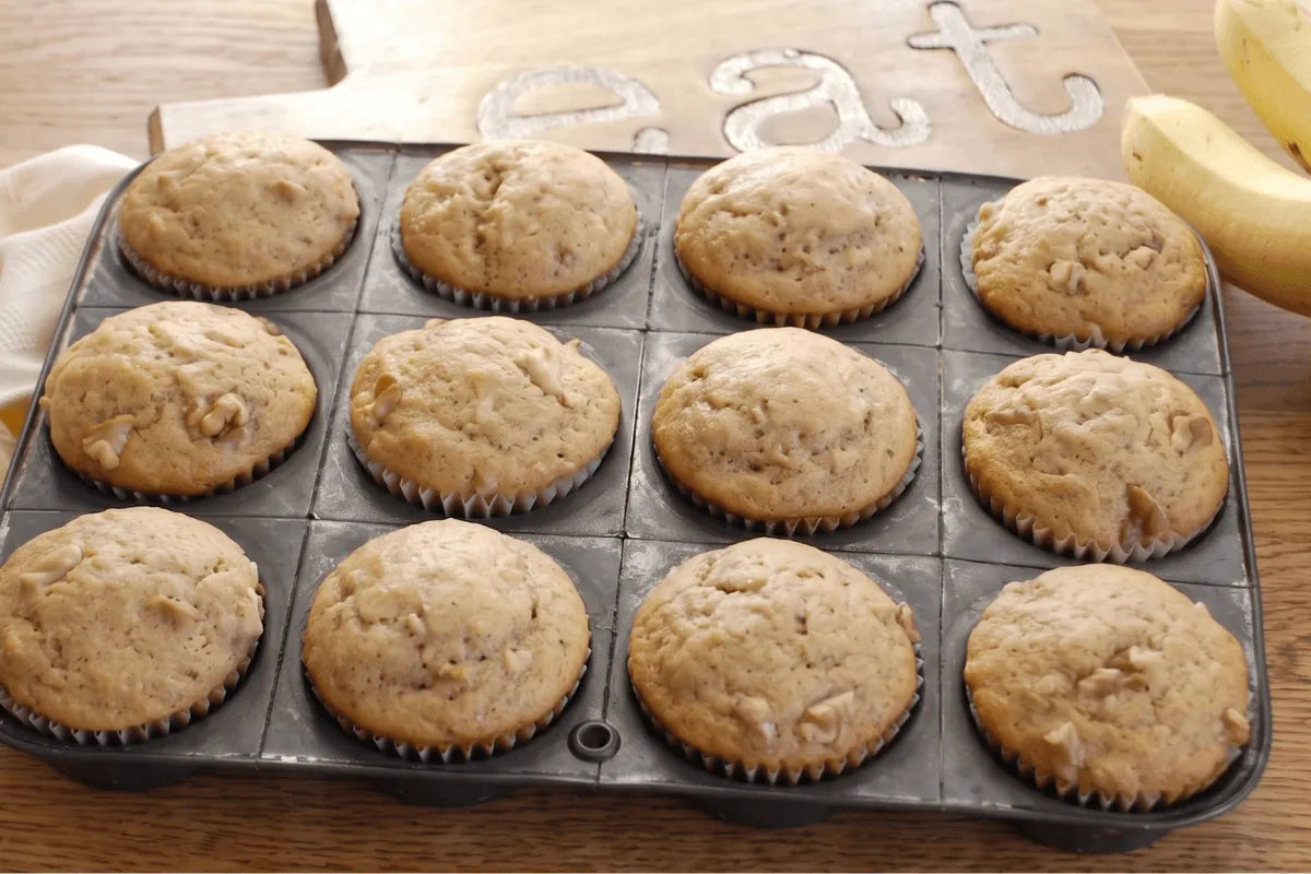 Gluten-free banana bread muffins cooling in a muffin pan
