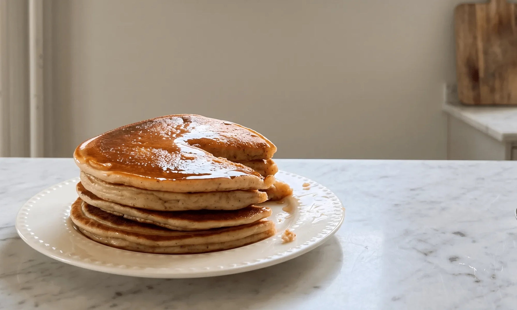 A stack of fluffy gluten-free cottage cheese protein pancakes with syrup