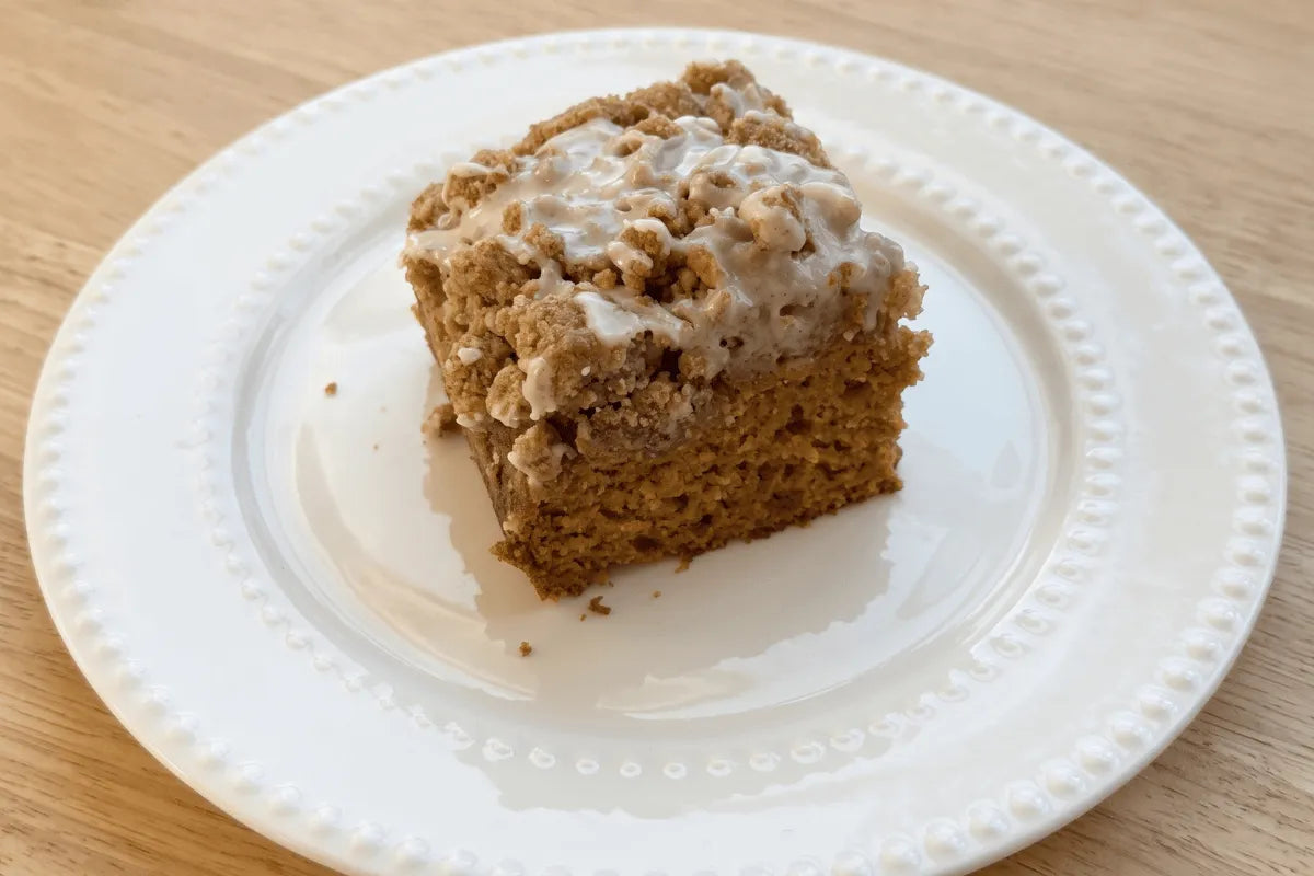Gluten-free pumpkin crumb cake with a thick brown sugar crumb topping and vanilla glaze