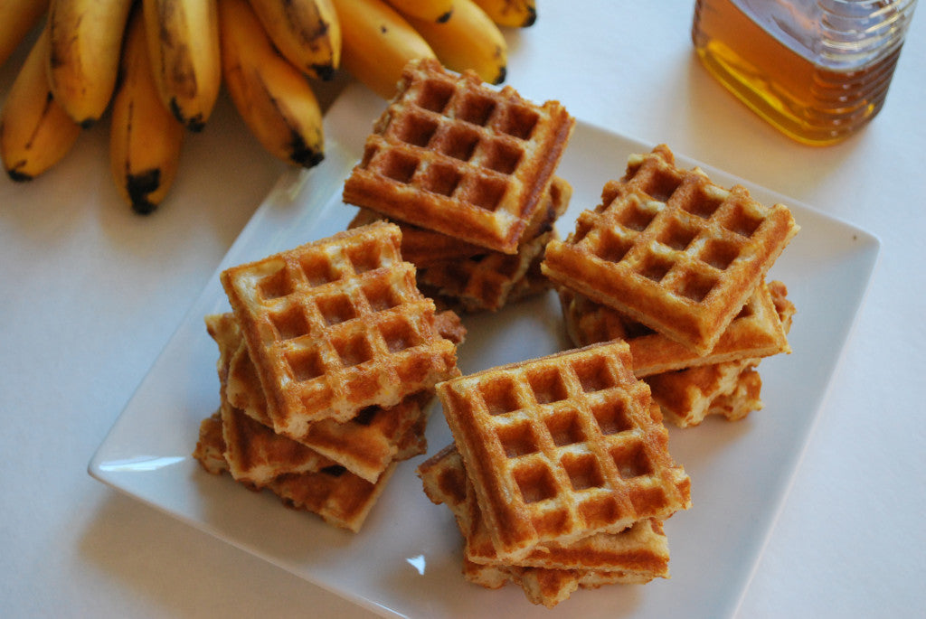 Crisp dairy-free gluten-free waffles on a plate with berries and syrup