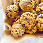 Chocolate chip cookies on a plate with brown paper